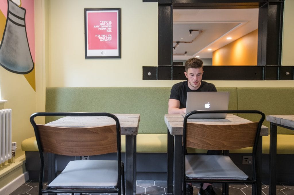Guest using workspace in the hotel to study.